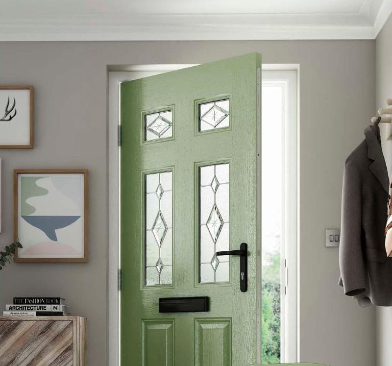 A sage green composite door with leaded glass